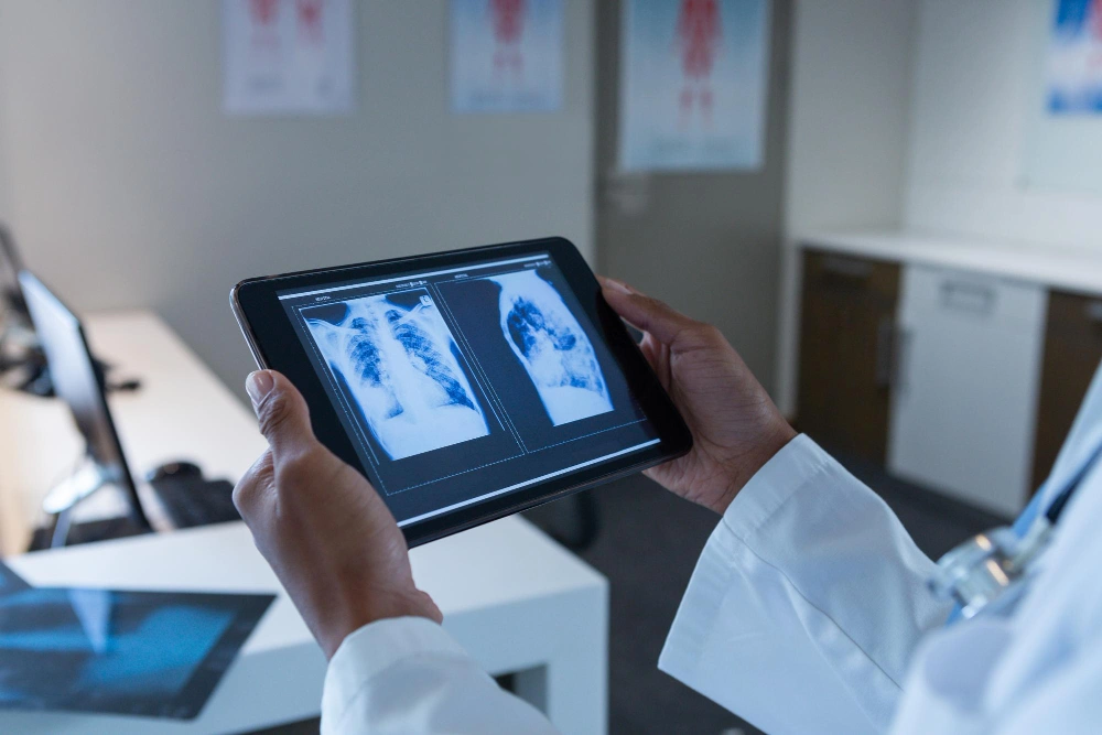 Female doctor examining xray on digital tablet